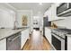 Modern kitchen with stainless steel appliances, granite countertops, and hardwood floors with an open layout at 121 Loon Dr, Summerville, SC 29483