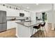 Bright kitchen features a large granite island with seating, stainless steel appliances, and white cabinetry at 121 Loon Dr, Summerville, SC 29483