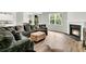 Cozy living room with a fireplace, large sectional sofa, hardwood floors, and natural light at 121 Loon Dr, Summerville, SC 29483