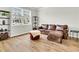 Inviting living room showcases a stylish leather sofa, ottoman, and large window with neighborhood views at 121 Loon Dr, Summerville, SC 29483