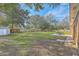 Spacious backyard with mature trees and a patio set for outdoor relaxation at 1247 Oakcrest Dr, Charleston, SC 29412