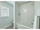Bathroom featuring a shower and bathtub combination with tile surround, and a window for natural light at 1247 Oakcrest Dr, Charleston, SC 29412