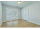 Bright, neutral bedroom with double windows and hardwood floors and a closet at 1247 Oakcrest Dr, Charleston, SC 29412