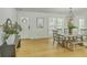 Bright dining room with wood floors and a stylish chandelier over a farmhouse table at 1247 Oakcrest Dr, Charleston, SC 29412