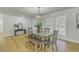 Well-lit dining area featuring modern table with bench seating and stylish chandelier at 1247 Oakcrest Dr, Charleston, SC 29412