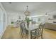 Open-concept kitchen and dining area with modern lighting and hardwood floors at 1247 Oakcrest Dr, Charleston, SC 29412