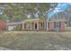 Charming brick home with a covered front porch and well-maintained lawn at 1247 Oakcrest Dr, Charleston, SC 29412