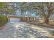 Beautiful brick home with mature trees, garage, and a long driveway at 1247 Oakcrest Dr, Charleston, SC 29412