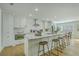 Bright kitchen boasts a large island with seating, white cabinets, and stainless steel appliances at 1247 Oakcrest Dr, Charleston, SC 29412