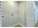 Laundry area with wooden floor and white walls with louvered bi-fold doors at 1247 Oakcrest Dr, Charleston, SC 29412