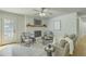 Cozy living room featuring a painted brick fireplace, comfortable seating, and plenty of natural light at 1247 Oakcrest Dr, Charleston, SC 29412