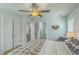 Cozy bedroom featuring a ceiling fan, plush bedding and an adjoining bathroom at 1247 Oakcrest Dr, Charleston, SC 29412