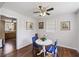 Cozy dining area with a round table, blue chairs, and a view into the kitchen, illuminated by a ceiling fan at 127 Ridge Rd, Summerville, SC 29485