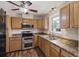 Modern kitchen with stainless steel oven, microwave, double sink, and wooden cabinets at 127 Ridge Rd, Summerville, SC 29485