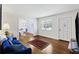 Bright living room with hardwood floors, a comfortable sofa, and an open layout to the dining area at 127 Ridge Rd, Summerville, SC 29485