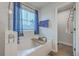 White soaking tub under window with blind and curtain, and wood caddy at 132 Mcclellan Way, Summerville, SC 29483