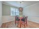 Cozy dining area with a modern light fixture, seating for four, and natural light from the window at 132 Mcclellan Way, Summerville, SC 29483