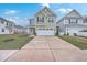 Two-story home with green siding, a two-car garage, and a long concrete driveway at 132 Mcclellan Way, Summerville, SC 29483