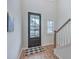 Light-filled foyer with black framed glass door and view of the staircase at 132 Mcclellan Way, Summerville, SC 29483