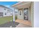 Charming front porch features white columns, a storm door and meticulous landscaping at 132 Mcclellan Way, Summerville, SC 29483