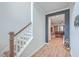 A view of the staircase with wooden handrails and a glimpse of the living room at 132 Mcclellan Way, Summerville, SC 29483