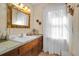 Well-lit bathroom with classic vanity, decorative mirror, and natural light from the window at 133 Stephanie Cir, Summerville, SC 29483