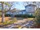 Charming two-story home features blue siding, complemented by mature trees and landscaping at 133 Stephanie Cir, Summerville, SC 29483