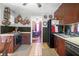 A kitchen featuring dark wood cabinets, tile floors, classic appliances, and view to adjacent dining room at 133 Stephanie Cir, Summerville, SC 29483