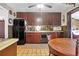Well-lit kitchen featuring dark wood cabinetry, neutral countertops, and efficient appliances at 133 Stephanie Cir, Summerville, SC 29483