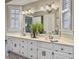 Bathroom featuring a double vanity with ample storage, a large mirror, and decorative accessories at 135 Ashley Hill Dr, Goose Creek, SC 29445