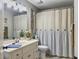 Cozy bathroom featuring a decorative mirror, striped shower curtain, and vanity at 135 Ashley Hill Dr, Goose Creek, SC 29445