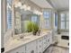 Bright bathroom with a double vanity, large mirror, ample lighting, and a soaking tub at 135 Ashley Hill Dr, Goose Creek, SC 29445