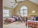 Bright bedroom with vaulted ceiling, two twin beds, a desk, and neutral carpet at 135 Ashley Hill Dr, Goose Creek, SC 29445