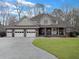 Charming home with a three-car garage, well-maintained lawn, and a welcoming front porch with rocking chairs at 135 Ashley Hill Dr, Goose Creek, SC 29445