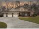 Charming home with a three-car garage, well-maintained lawn, and a welcoming front porch with rocking chairs at 135 Ashley Hill Dr, Goose Creek, SC 29445