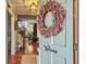 Bright foyer featuring hardwood floors, an elegant wreath, and a glimpse into the living room at 135 Ashley Hill Dr, Goose Creek, SC 29445