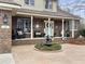 Inviting front porch with a decorative fountain, rocking chairs, and a charming entrance at 135 Ashley Hill Dr, Goose Creek, SC 29445