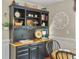 A beautiful black hutch in the dining room with decorations and hardwood floors at 135 Ashley Hill Dr, Goose Creek, SC 29445