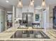 A kitchen island featuring hardwood floors, a cooktop, granite countertops, and stainless steel appliances at 135 Ashley Hill Dr, Goose Creek, SC 29445