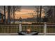 Scenic view from the deck featuring a fire pit, golf course, and lake at sunset at 135 Ashley Hill Dr, Goose Creek, SC 29445