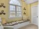 Bright window seat nook with a large arched window, neutral tones and accent propeller art pieces at 135 Ashley Hill Dr, Goose Creek, SC 29445