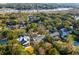 Aerial view showcasing a neighborhood with beautiful homes nestled amongst trees and near a body of water at 14 Guerard Rd, Charleston, SC 29407