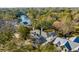 Aerial view of a home and neighborhood, nestled among lush trees with a view of the nearby river at 14 Guerard Rd, Charleston, SC 29407