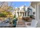 Charming backyard featuring a deck, outdoor seating, beautiful landscaping, and a white brick house at 14 Guerard Rd, Charleston, SC 29407
