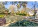 Large backyard with green grass, brick-lined patio, and lush landscaping create a serene outdoor space at 14 Guerard Rd, Charleston, SC 29407