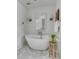Luxurious bathroom featuring a soaking tub, a wooden stool and marble floors at 14 Guerard Rd, Charleston, SC 29407