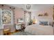 Pink bedroom with a bed, makeup table, and natural light from the window creating a cozy space at 14 Guerard Rd, Charleston, SC 29407