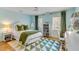 Bright bedroom featuring light blue walls, hardwood floors, and natural light from two windows at 14 Guerard Rd, Charleston, SC 29407