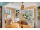 Bright dining area featuring a model sailboat, glass-front cabinets, and beautiful hardwood floors at 14 Guerard Rd, Charleston, SC 29407