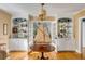 Bright dining area featuring a model sailboat, glass-front cabinets, and beautiful hardwood floors at 14 Guerard Rd, Charleston, SC 29407